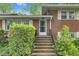 Brick stairway leading to the front door with manicured bushes on either side of the entryway at 905 Cindy St, Cary, NC 27511