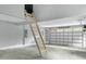 Garage showcasing an attic ladder, a large open layout, and plenty of natural light from the door window at 905 Cindy St, Cary, NC 27511