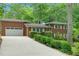 Side view of a brick home with a long driveway leading to an attached two-car garage at 905 Cindy St, Cary, NC 27511