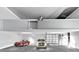 Spacious garage featuring a mezzanine level, natural lighting, and parking for two vehicles at 905 Cindy St, Cary, NC 27511
