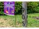 Close-up of the house numbers, '905', on a wooden post beside a decorative dragonfly flag at 905 Cindy St, Cary, NC 27511