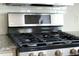 A close up of a new stainless steel LG gas range with black cooktop at 905 Cindy St, Cary, NC 27511