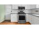 Updated kitchen featuring stainless steel range, microwave, white cabinets, and granite countertops at 905 Cindy St, Cary, NC 27511