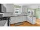 Updated kitchen featuring stainless steel appliances, granite countertops, and white cabinets at 905 Cindy St, Cary, NC 27511