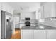 Bright kitchen featuring stainless steel appliances, white cabinets, and granite countertops at 905 Cindy St, Cary, NC 27511
