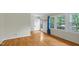 Sunlit living room features hardwood floors, neutral walls, and large windows, perfect for relaxation at 905 Cindy St, Cary, NC 27511
