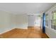 Bright, hardwood floored living room with large windows and neutral walls create a welcoming atmosphere at 905 Cindy St, Cary, NC 27511