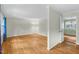 Spacious living room with hardwood floors, neutral paint, and an open doorway to another room at 905 Cindy St, Cary, NC 27511