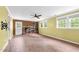 Spacious living room featuring a brick fireplace, wood-look floors, and plenty of natural light at 905 Cindy St, Cary, NC 27511