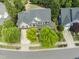 Aerial view of a beautiful home with a well-manicured lawn and mature trees in a quiet neighborhood at 909 Grogans Mill Dr, Cary, NC 27519
