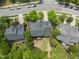 Aerial view of the home with a spacious backyard and tree coverage in a residential community at 909 Grogans Mill Dr, Cary, NC 27519