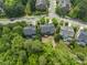 Aerial view of homes with manicured lawns in a neighborhood with mature trees and well maintained landscaping at 909 Grogans Mill Dr, Cary, NC 27519