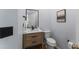 Powder room featuring a modern vanity with wood accents and a black faucet at 909 Grogans Mill Dr, Cary, NC 27519