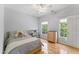 Bright bedroom with a ceiling fan, a bed, hardwood floors, a bookshelf and a chest of drawers at 909 Grogans Mill Dr, Cary, NC 27519