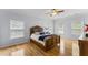 Large Primary bedroom with a ceiling fan, a bed, hardwood floors and plenty of natural light at 909 Grogans Mill Dr, Cary, NC 27519