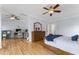 Spacious bedroom with light-blue walls and wooden floors, features an office space and a ceiling fan at 909 Grogans Mill Dr, Cary, NC 27519
