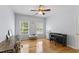 Bedroom with hardwood floors, a ceiling fan, natural light, and a desk with a piano at 909 Grogans Mill Dr, Cary, NC 27519