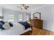 Large bedroom with hardwood floors, a mirror and a bed at 909 Grogans Mill Dr, Cary, NC 27519