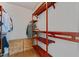 Walk-in closet with custom shelving, wooden drawers, and wood floors at 909 Grogans Mill Dr, Cary, NC 27519