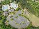 Aerial view of community pool, playground and clubhouse and a spacious parking lot area at 909 Grogans Mill Dr, Cary, NC 27519