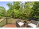 A deck area offers seating with relaxing backyard views at 909 Grogans Mill Dr, Cary, NC 27519