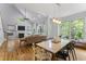 Open dining area with fireplace, large windows and an elegant table setting for modern living at 909 Grogans Mill Dr, Cary, NC 27519