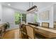 Formal dining room with modern lighting, large windows, and elegant decor for sophisticated meals at 909 Grogans Mill Dr, Cary, NC 27519