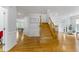 Foyer with hardwood floors and a wooden staircase leading to the upper level at 909 Grogans Mill Dr, Cary, NC 27519