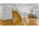 Open foyer with wooden staircase and hardwood flooring, leading to the living and dining areas at 909 Grogans Mill Dr, Cary, NC 27519