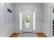Bright foyer with a white door, decorative glass, and wood flooring at 909 Grogans Mill Dr, Cary, NC 27519