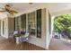 Inviting covered front porch with furniture, views, and ceiling fans at 909 Grogans Mill Dr, Cary, NC 27519