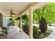 Inviting covered front porch with ceiling fans, furniture, and view of the landscaped front yard at 909 Grogans Mill Dr, Cary, NC 27519