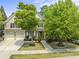 Charming two-story home with a two car garage and landscaped front yard, including lush green trees at 909 Grogans Mill Dr, Cary, NC 27519