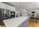 Modern kitchen with gray lower cabinets, a quartz countertop island, and stainless steel appliances at 909 Grogans Mill Dr, Cary, NC 27519