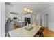 Bright kitchen with stainless appliances, an island, and adjoining dining area under pendant lights at 909 Grogans Mill Dr, Cary, NC 27519