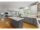 Modern kitchen featuring an island, white cabinets, stainless steel appliances, and open layout at 909 Grogans Mill Dr, Cary, NC 27519