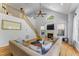 Bright living room with vaulted ceilings, lots of natural light, a fireplace, and open staircase at 909 Grogans Mill Dr, Cary, NC 27519