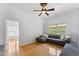 Upstairs living room with hardwood floors, a ceiling fan, and a large sectional sofa at 909 Grogans Mill Dr, Cary, NC 27519