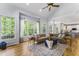 Bright living room boasts hardwood floors, large windows and a comfortable sectional sofa at 909 Grogans Mill Dr, Cary, NC 27519