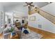 Open-concept living room features hardwood floors, staircase, and seamless flow to the kitchen at 909 Grogans Mill Dr, Cary, NC 27519
