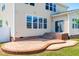 Charming backyard patio with elegant design and stairs leading to the home at 112 Gadsbury Dr, Holly Springs, NC 27540