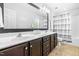Bathroom featuring a double vanity with dark cabinets and a large framed mirror at 112 Gadsbury Dr, Holly Springs, NC 27540