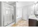 Bright bathroom with a glass shower, soaking tub, and double vanity at 112 Gadsbury Dr, Holly Springs, NC 27540