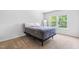 Minimalist bedroom featuring plush carpet, a standing mirror, and ample natural light at 112 Gadsbury Dr, Holly Springs, NC 27540