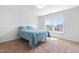 Neutral bedroom with plush carpet and a large window providing natural light at 112 Gadsbury Dr, Holly Springs, NC 27540