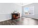 Bright dining room featuring hardwood flooring, a modern chandelier and lots of natural light at 112 Gadsbury Dr, Holly Springs, NC 27540