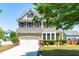 Charming two-story home featuring a two-car garage and manicured front lawn with garden at 112 Gadsbury Dr, Holly Springs, NC 27540