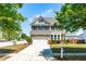 Two-story home boasts a manicured lawn, two-car garage, and classic shuttered windows at 112 Gadsbury Dr, Holly Springs, NC 27540