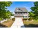 Two story home featuring well maintained lawn, two car garage, and shuttered windows at 112 Gadsbury Dr, Holly Springs, NC 27540