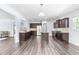 Open concept kitchen with stainless steel appliances, granite countertops, and hardwood floors at 112 Gadsbury Dr, Holly Springs, NC 27540